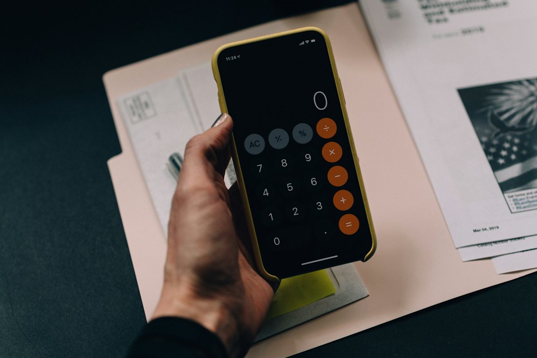 A calculator and financial paperwork on a desk